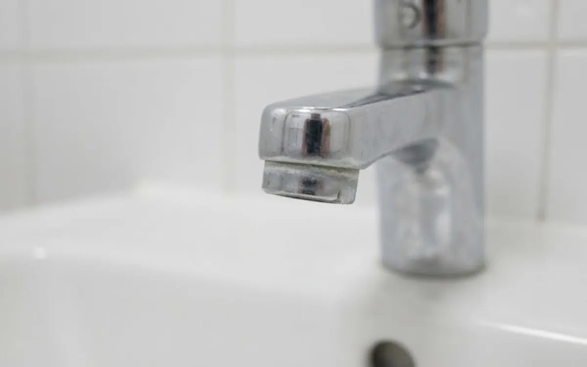 Chrome bathroom faucet where Meridian hard water leaves mineral scale